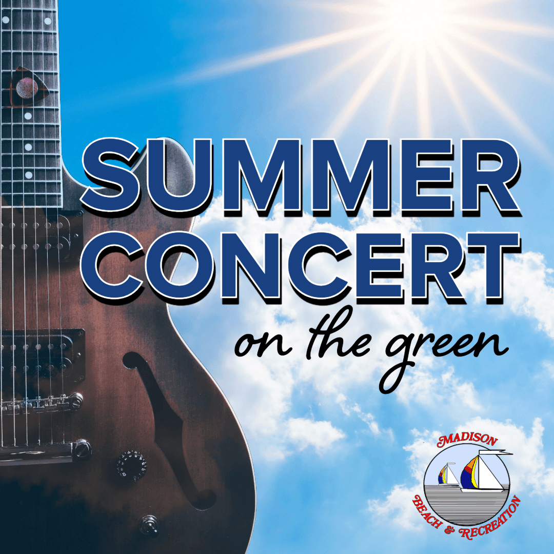 summer concert on the green, Guitar held up against  bright sky with white puffy clouds